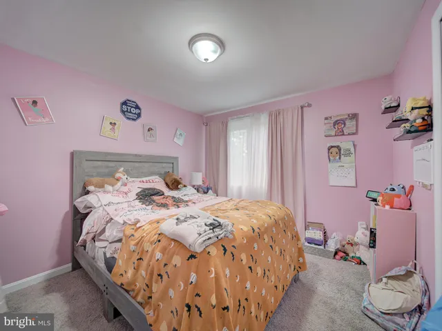 a bedroom with a bed and a table in it