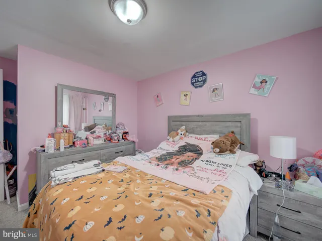 a bed room with a bed and a dresser