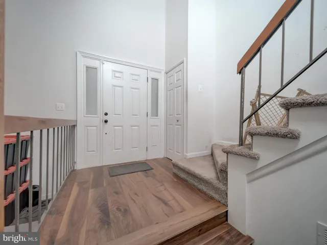 a view of a livingroom with wooden floor and stairs