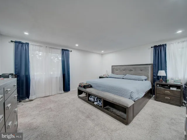a bedroom with a bed and a television