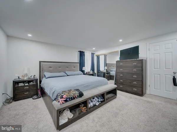 a spacious bedroom with a bed and furniture