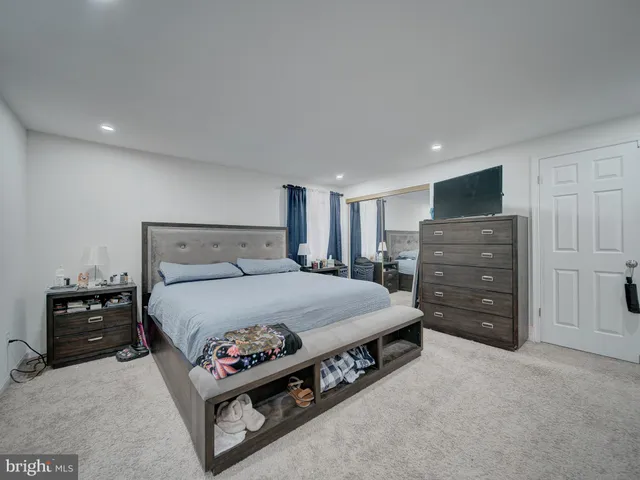 a spacious bedroom with a bed and furniture