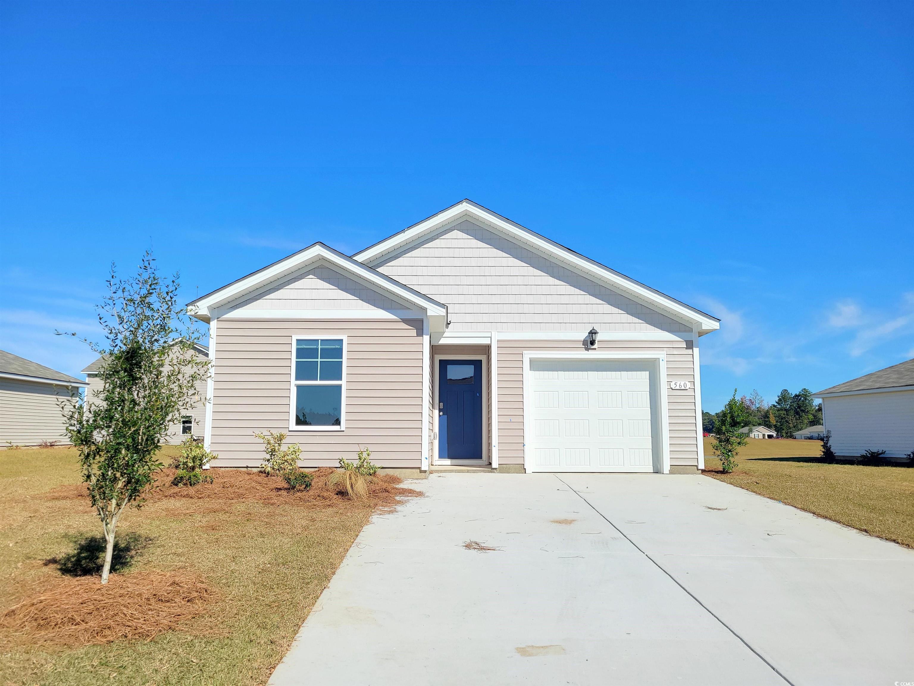Single story home with concrete driveway, a garage, and a front lawn