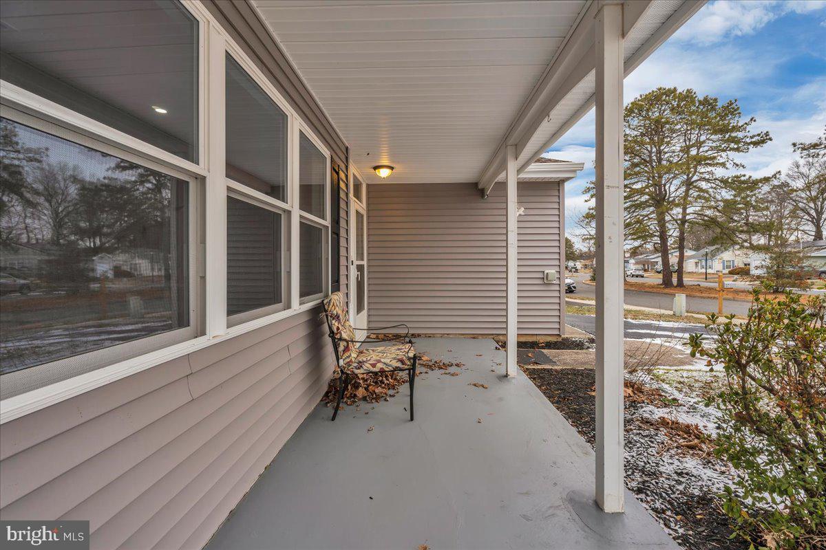 39 Chelsea Place Southampton, NJ 08088 - Photo 2 of 23 a porch with a table and chairs
