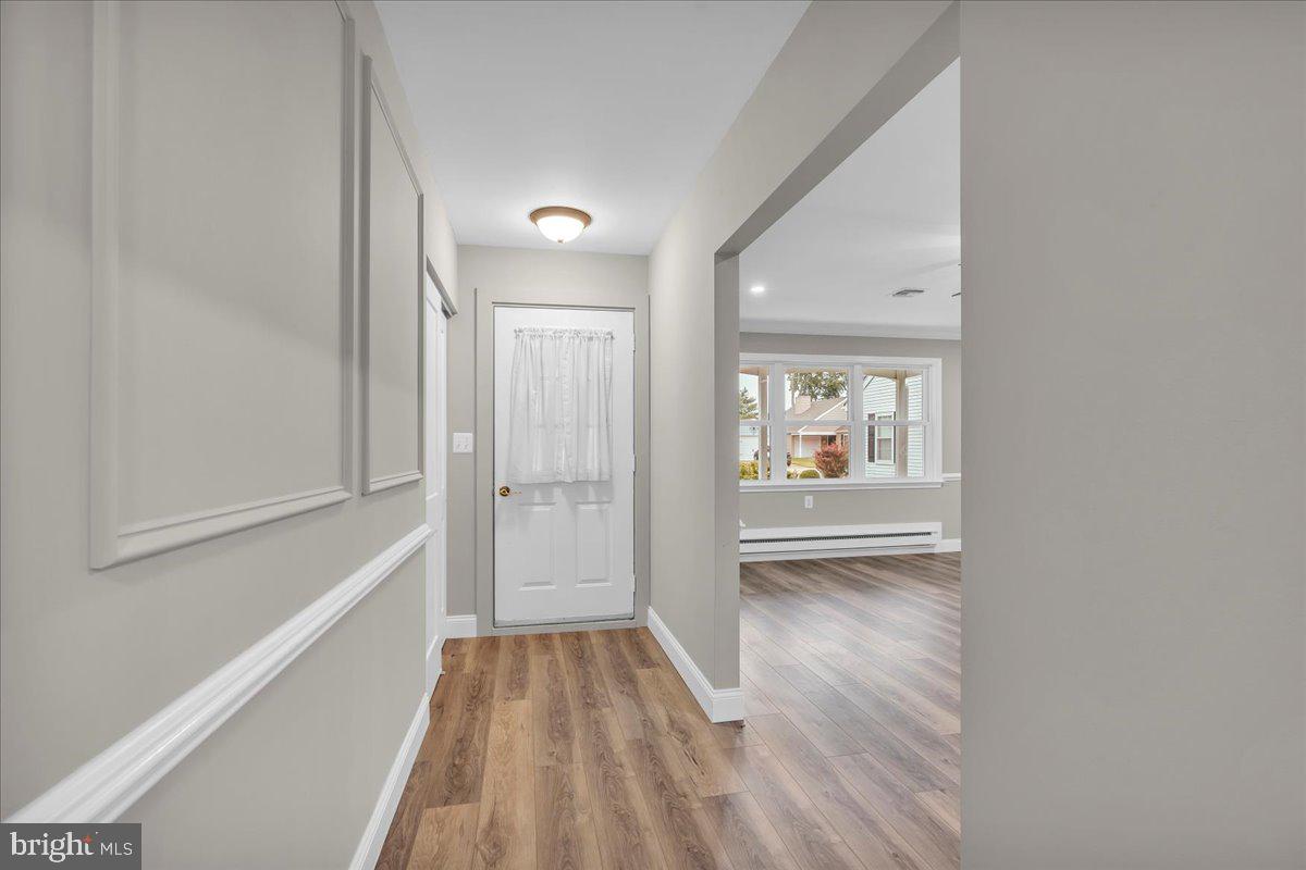 39 Chelsea Place Southampton, NJ 08088 - Photo 3 of 23 a view of a hallway with wooden floor and a living room