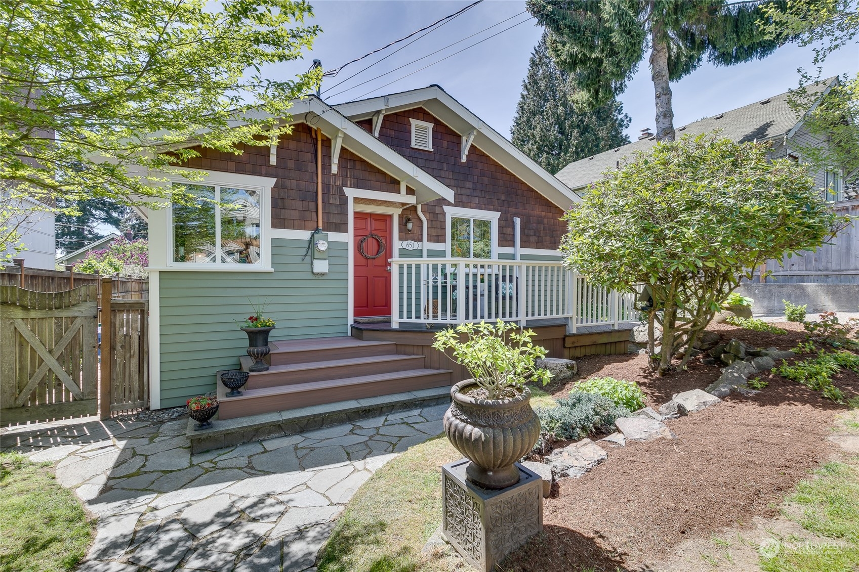 651 Northwest 89th Street Seattle, WA 98117 - Photo 1 of 38 a front view of a house with a garden