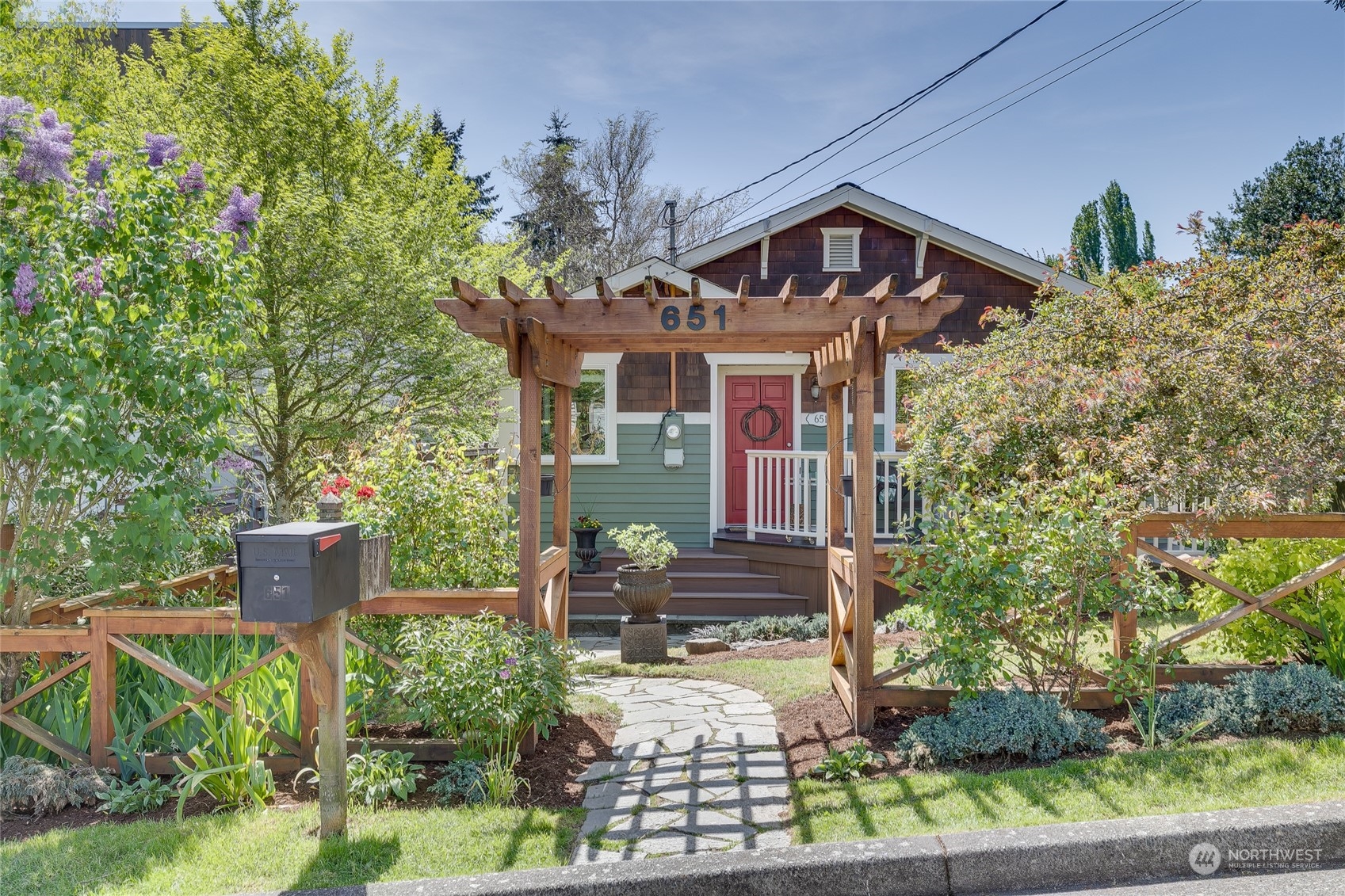 651 Northwest 89th Street Seattle, WA 98117 - Photo 2 of 38 a front view of a house with a yard