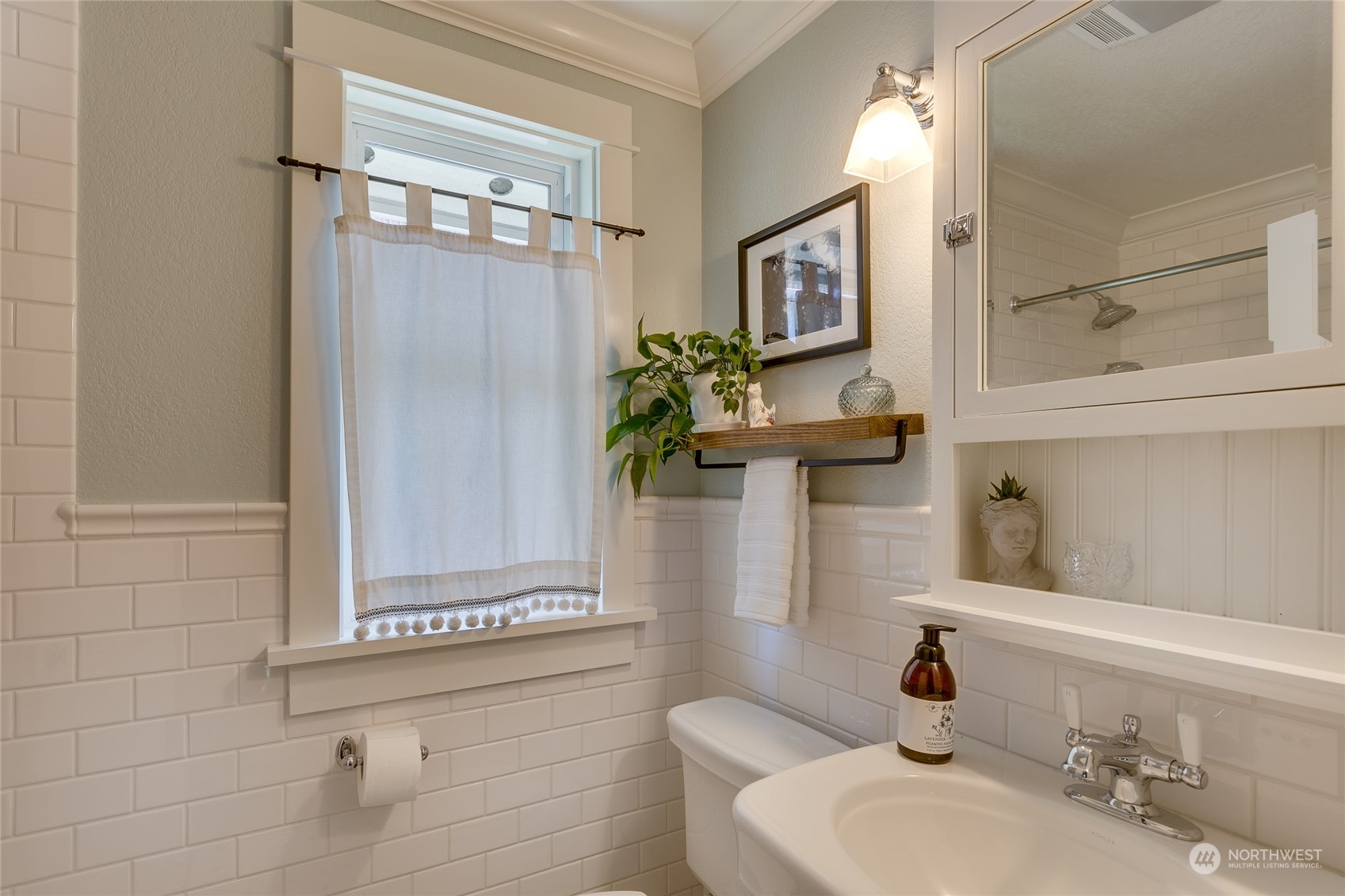 651 Northwest 89th Street Seattle, WA 98117 - Photo 26 of 38 a bathroom with a granite countertop sink a mirror and shower