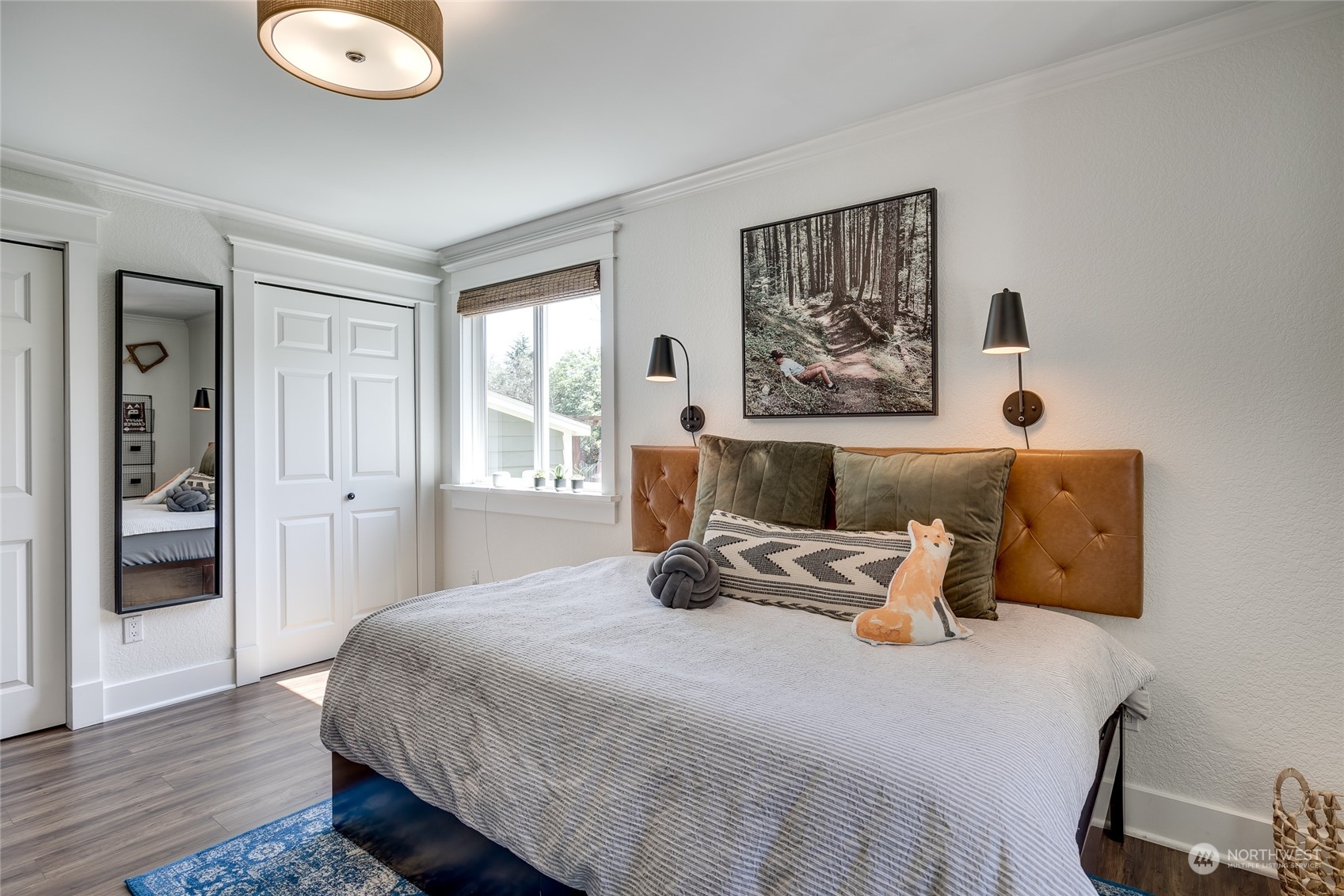 651 Northwest 89th Street Seattle, WA 98117 - Photo 30 of 38 a bedroom with a bed and wooden floor