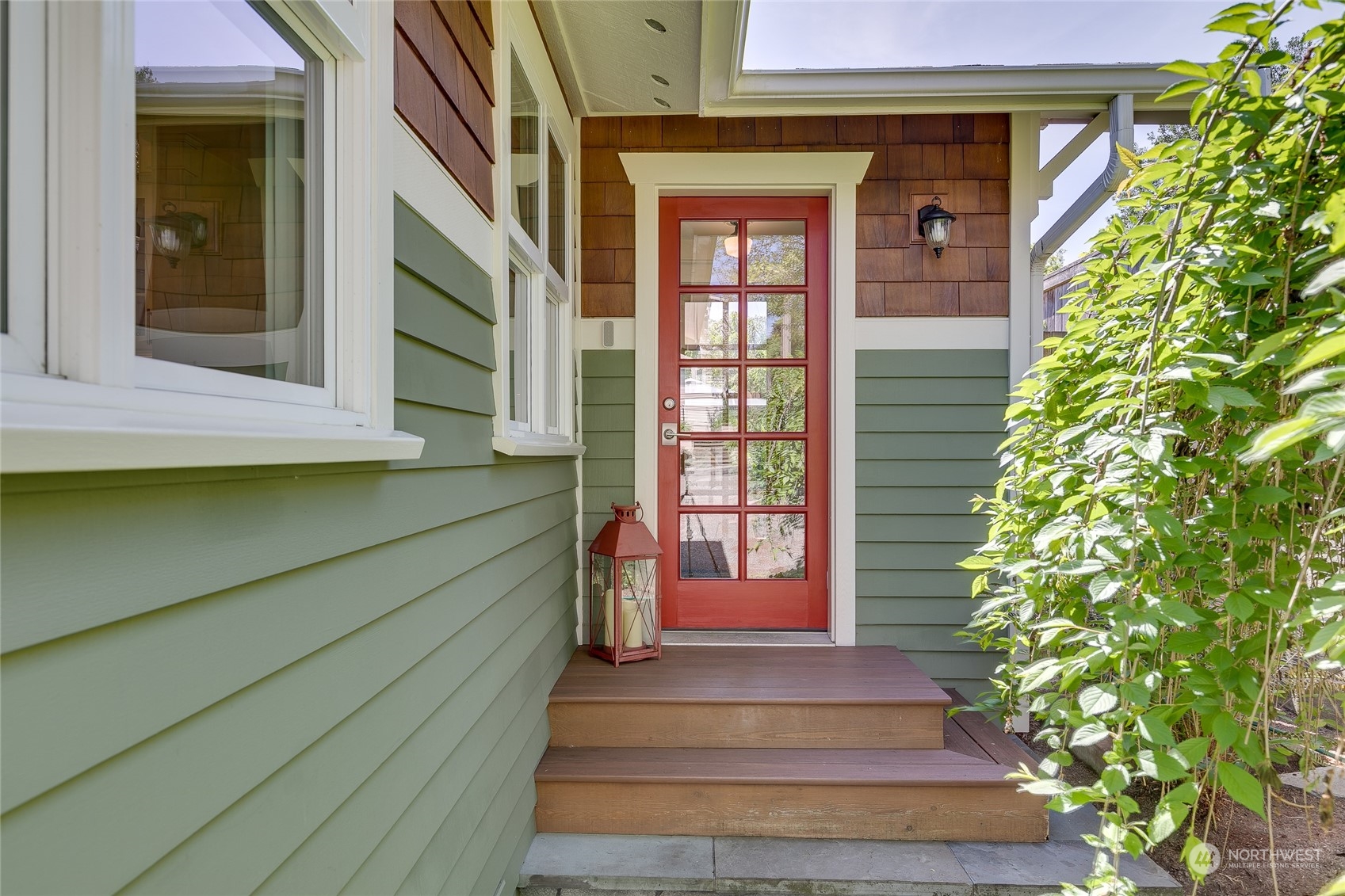 651 Northwest 89th Street Seattle, WA 98117 - Photo 5 of 38 a front view of a house with a plants and more windows