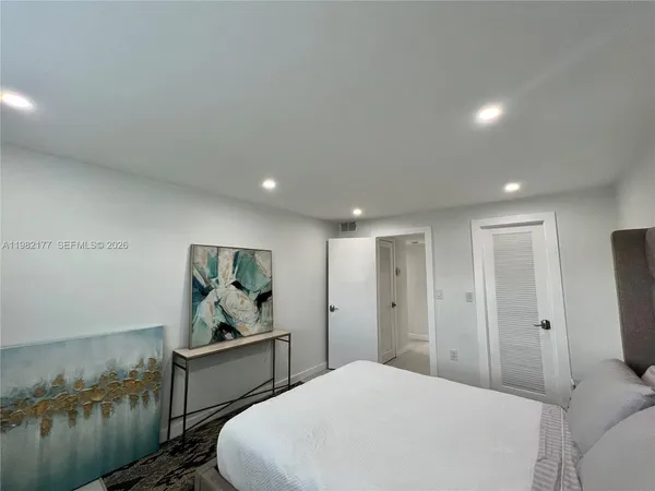 a spacious bedroom with a bed and a couch