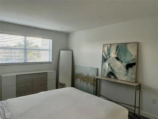 a bedroom with a bed and a mirror