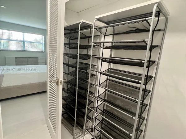 a view of walk in closet with empty racks