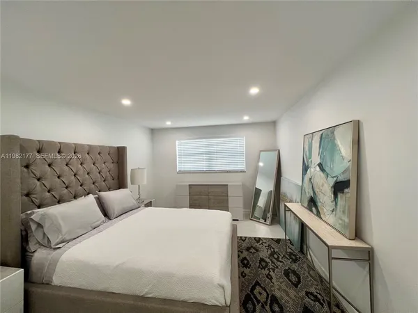 a bedroom with a large bed and a couch