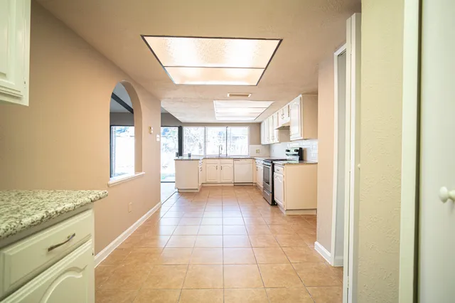 a view of a kitchen with a sink and dishwasher cabinets