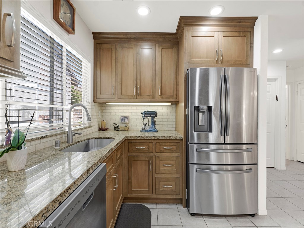 5621 Daisy Street Simi Valley, CA 93063 - Photo 13 of 31 a kitchen with stainless steel appliances granite countertop a refrigerator a sink and white cabinets