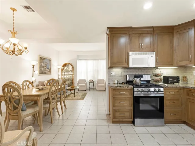 a kitchen with stainless steel appliances granite countertop a stove and cabinets