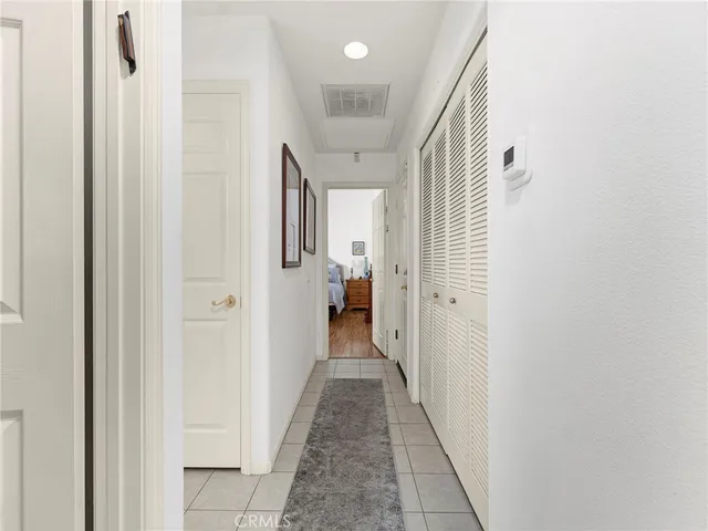 a view of a hallway with wooden shelves