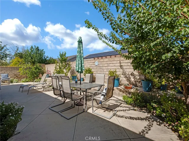 a view of a patio with table and chairs and potted plants