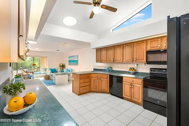 a kitchen with stainless steel appliances granite countertop a sink dishwasher stove top oven and cabinets with wooden floor