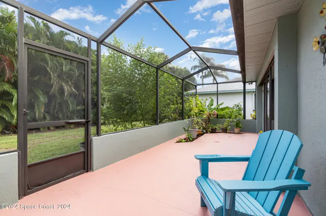 a view of a porch with furniture and garden