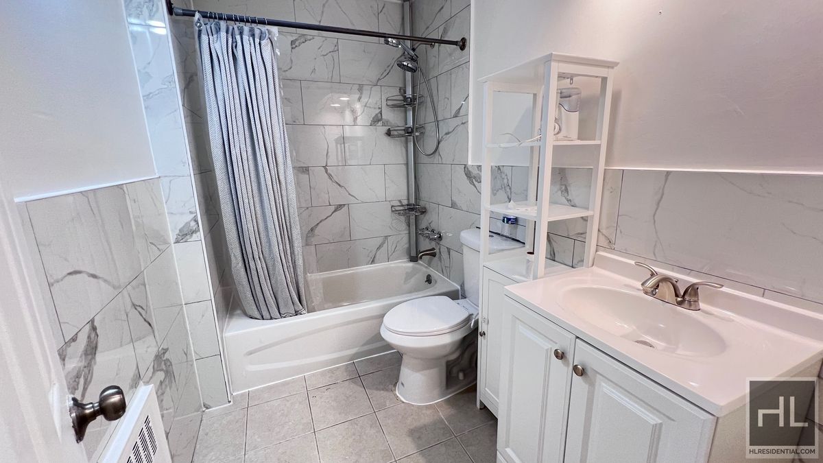 2070 East 55th Street, Unit 2 Brooklyn, NY 11234 - Photo 12 of 23 a bathroom with a sink toilet and shower