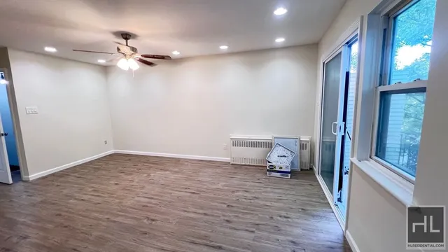 a view of a room with wooden floor