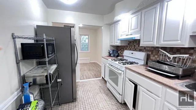 a kitchen with stainless steel appliances a stove a microwave and a refrigerator
