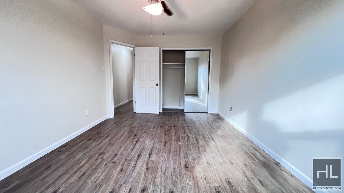 2070 East 55th Street, Unit 2 Brooklyn, NY 11234 - Photo 8 of 23 a view of an empty room with wooden floor