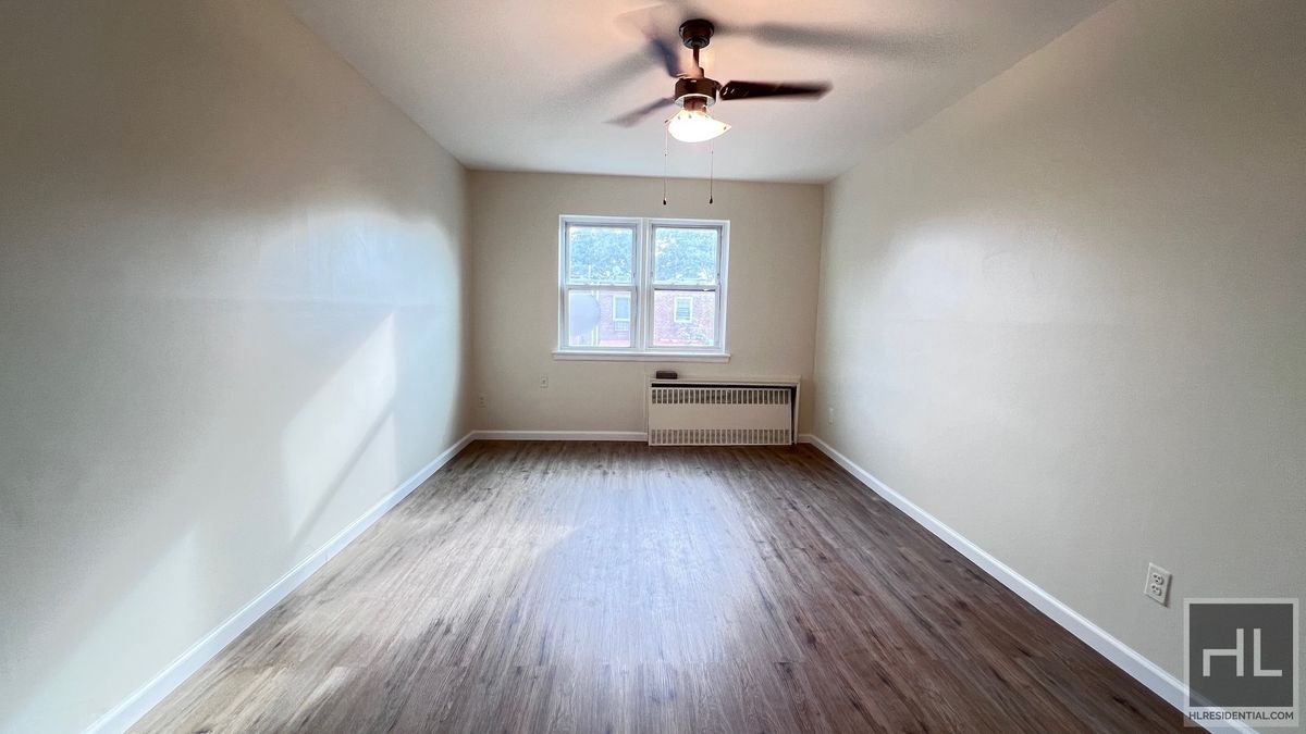 2070 East 55th Street, Unit 2 Brooklyn, NY 11234 - Photo 10 of 23 a view of room with window ceiling fan and hardwood floor