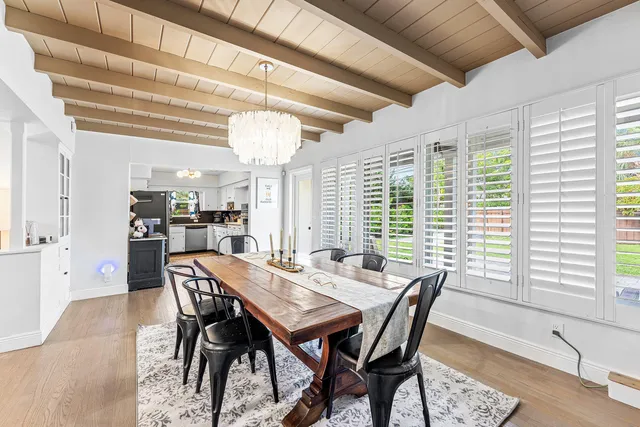 a view of a dining room with furniture and a chandelier