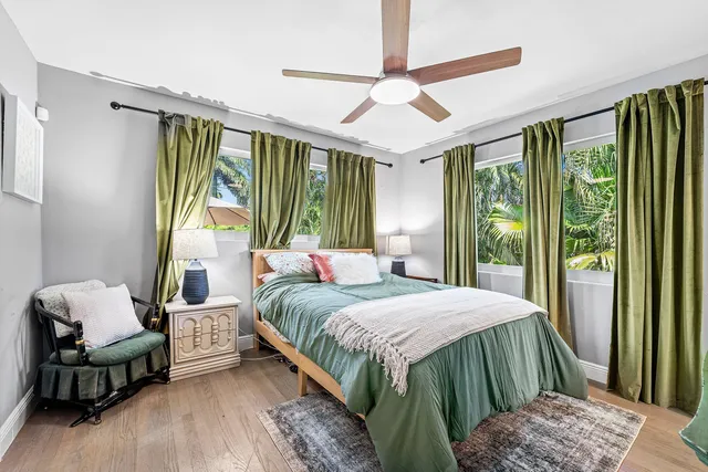 a bedroom with a bed and large window