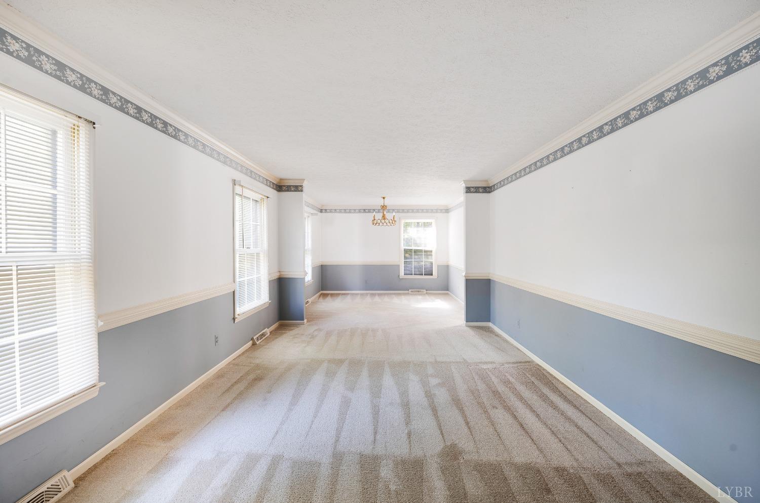 101 Foxhall Drive Forest, VA 24551 - Photo 17 of 54 a view of a big room with wooden floor and windows