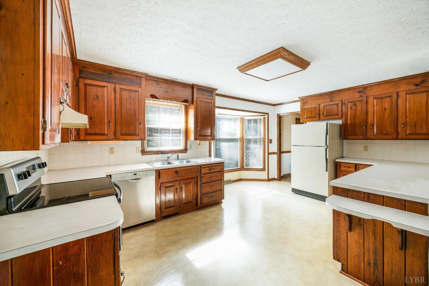 101 Foxhall Drive Forest, VA 24551 - Photo 22 of 54 a large kitchen with stainless steel appliances granite countertop a stove a sink dishwasher and a refrigerator with white cabinets
