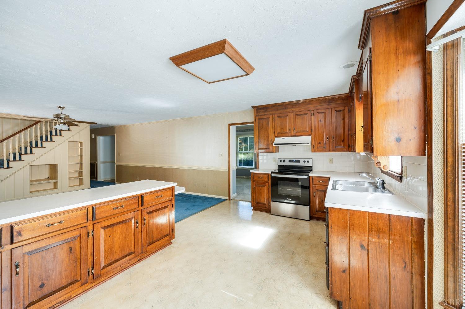 101 Foxhall Drive Forest, VA 24551 - Photo 23 of 54 a kitchen with stainless steel appliances granite countertop a stove a sink and a microwave
