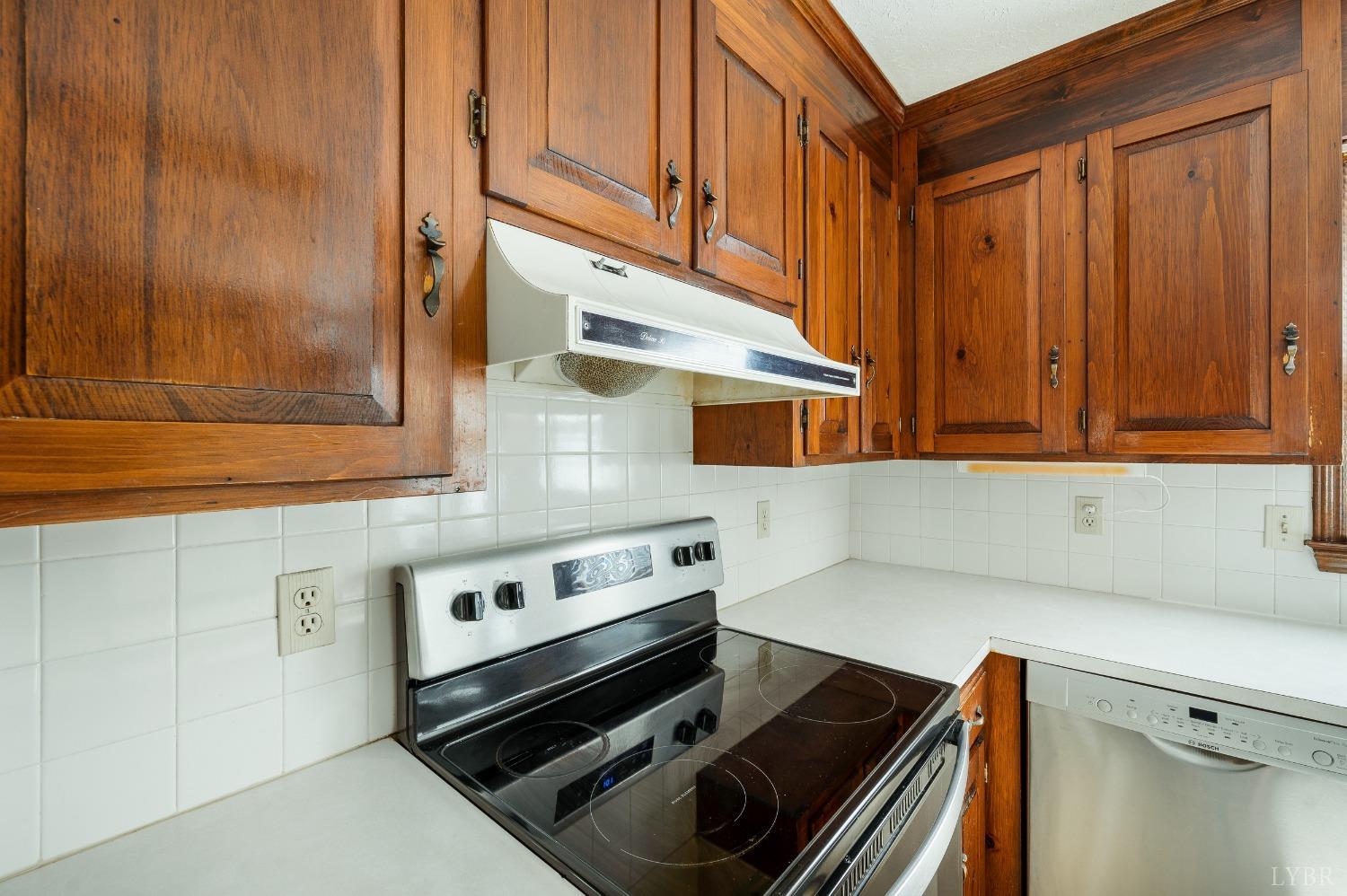 101 Foxhall Drive Forest, VA 24551 - Photo 28 of 54 a kitchen with wooden cabinets and a stove top oven