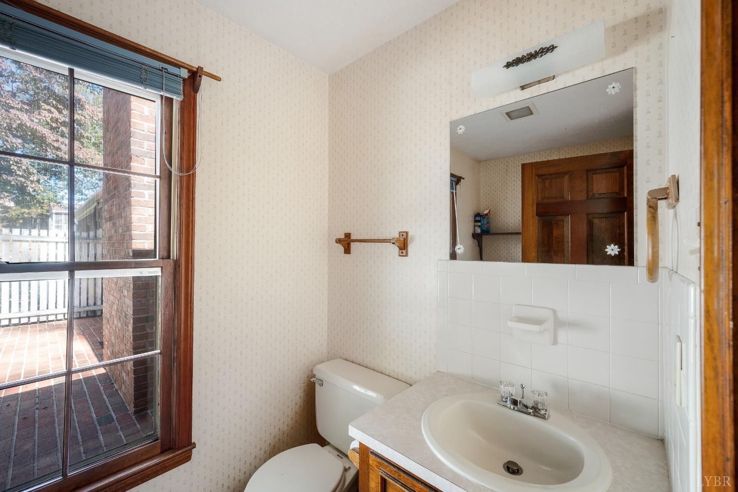 101 Foxhall Drive Forest, VA 24551 - Photo 48 of 54 a bathroom with a sink and mirror with toilet