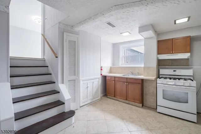 an empty room with entrance and windows