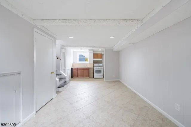a kitchen with a stove sink and cabinets