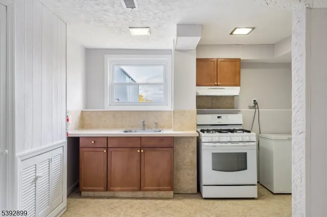 a view of room with wooden floor and windows