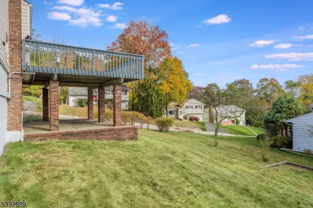 a view of a house with backyard and porch