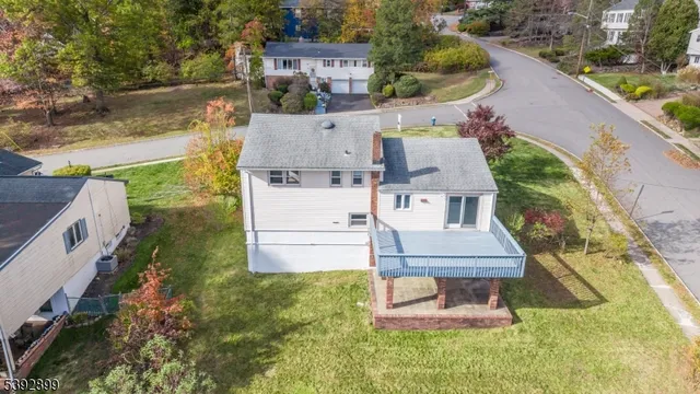 an aerial view of a house with a yard and potted plants