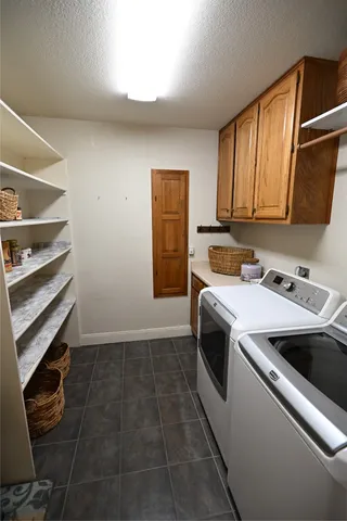 a view of a kitchen with a sink a microwave and cabinets