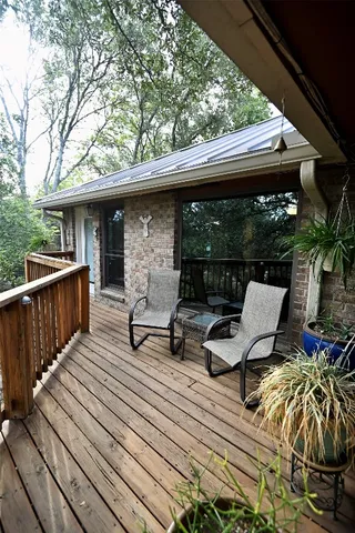 a view of roof deck with wooden floor and outdoor seating