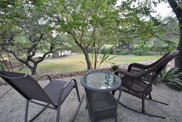 a view of a backyard with large trees