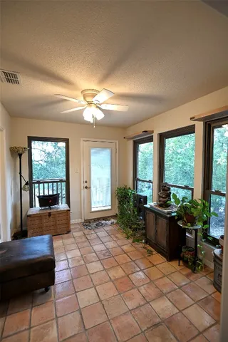 a living room with furniture and large windows