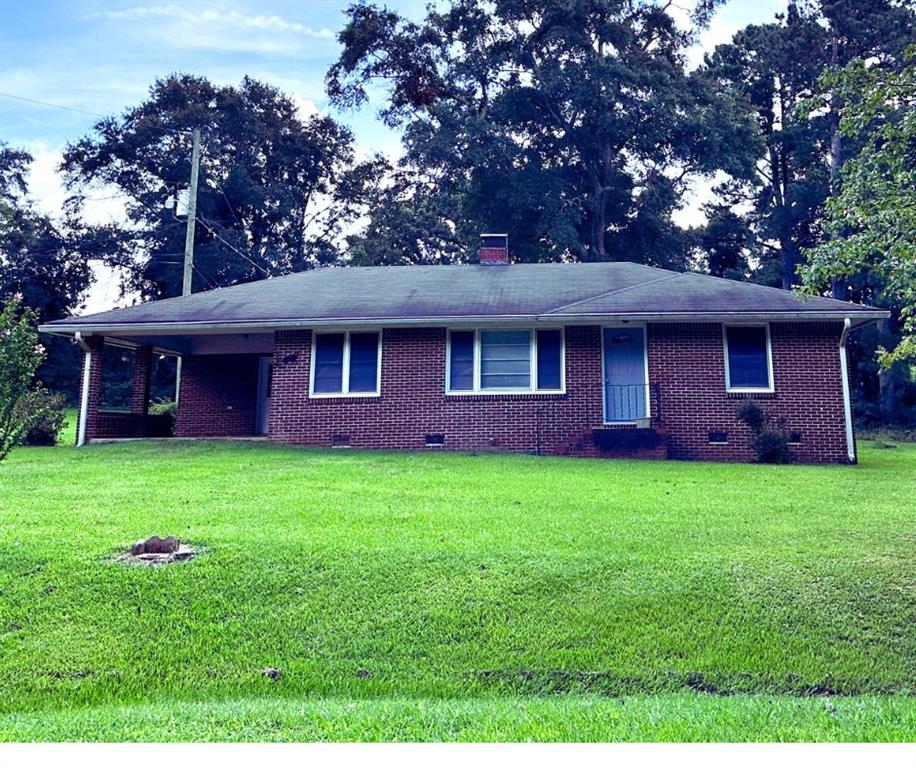 3099 Old Broadnax Mill Road Loganville, GA 30052 - Photo 1 of 1 a front view of a house with a garden