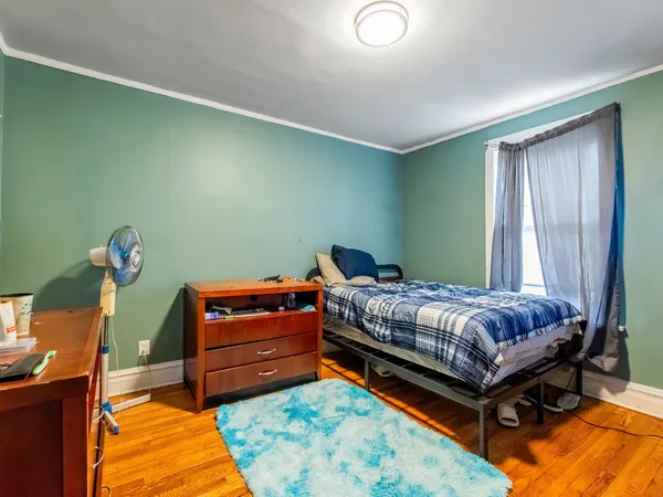 a bedroom with a bed and a window
