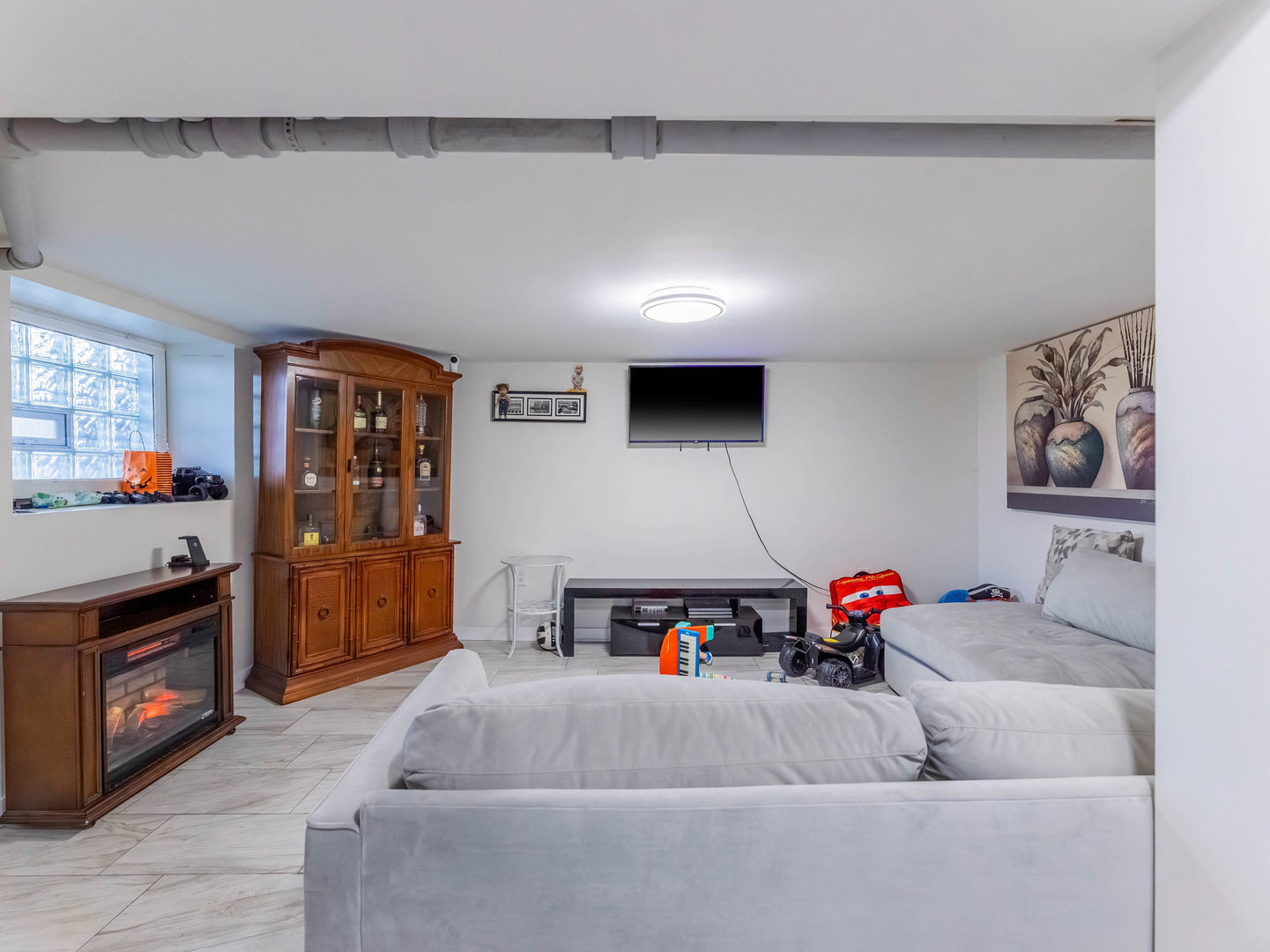 4747 West Monroe Street Chicago, IL 60644 - Photo 17 of 25 a living room with furniture and a flat screen tv