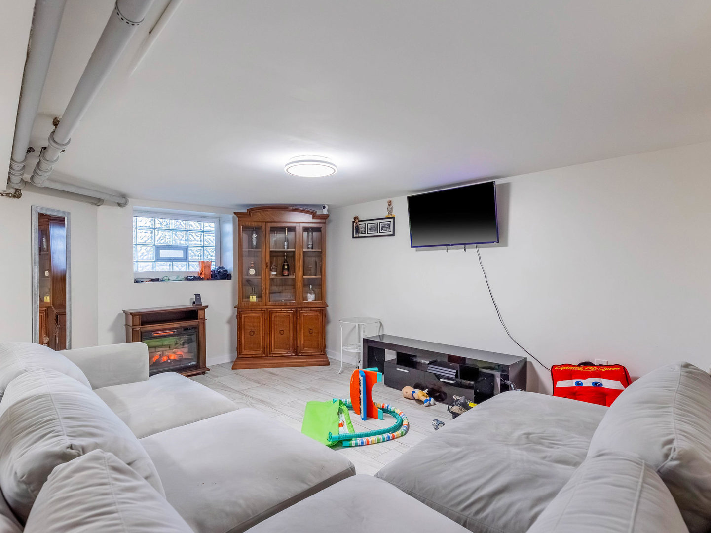 4747 West Monroe Street Chicago, IL 60644 - Photo 18 of 25 a living room with furniture and a flat screen tv